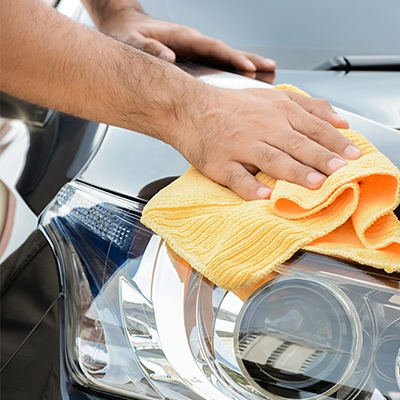 detail time employee washing a car