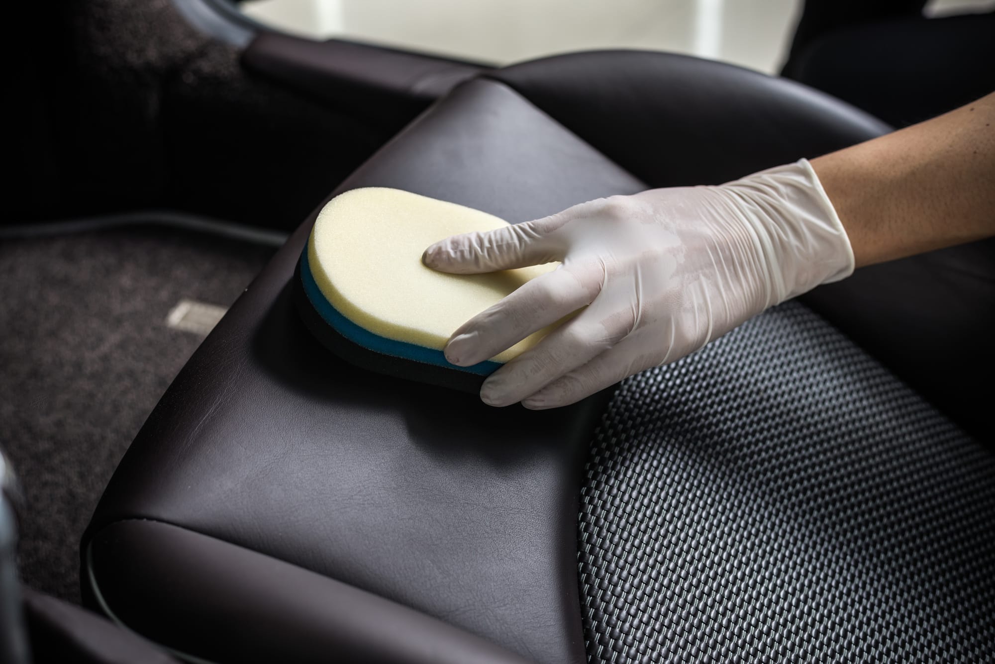 a hand servicing a car interior