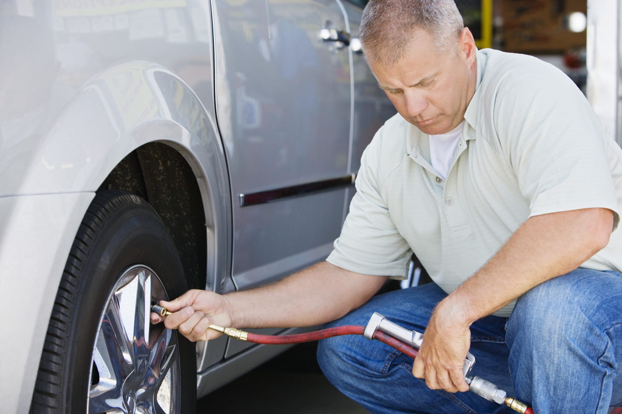 a man filling a tire qith air