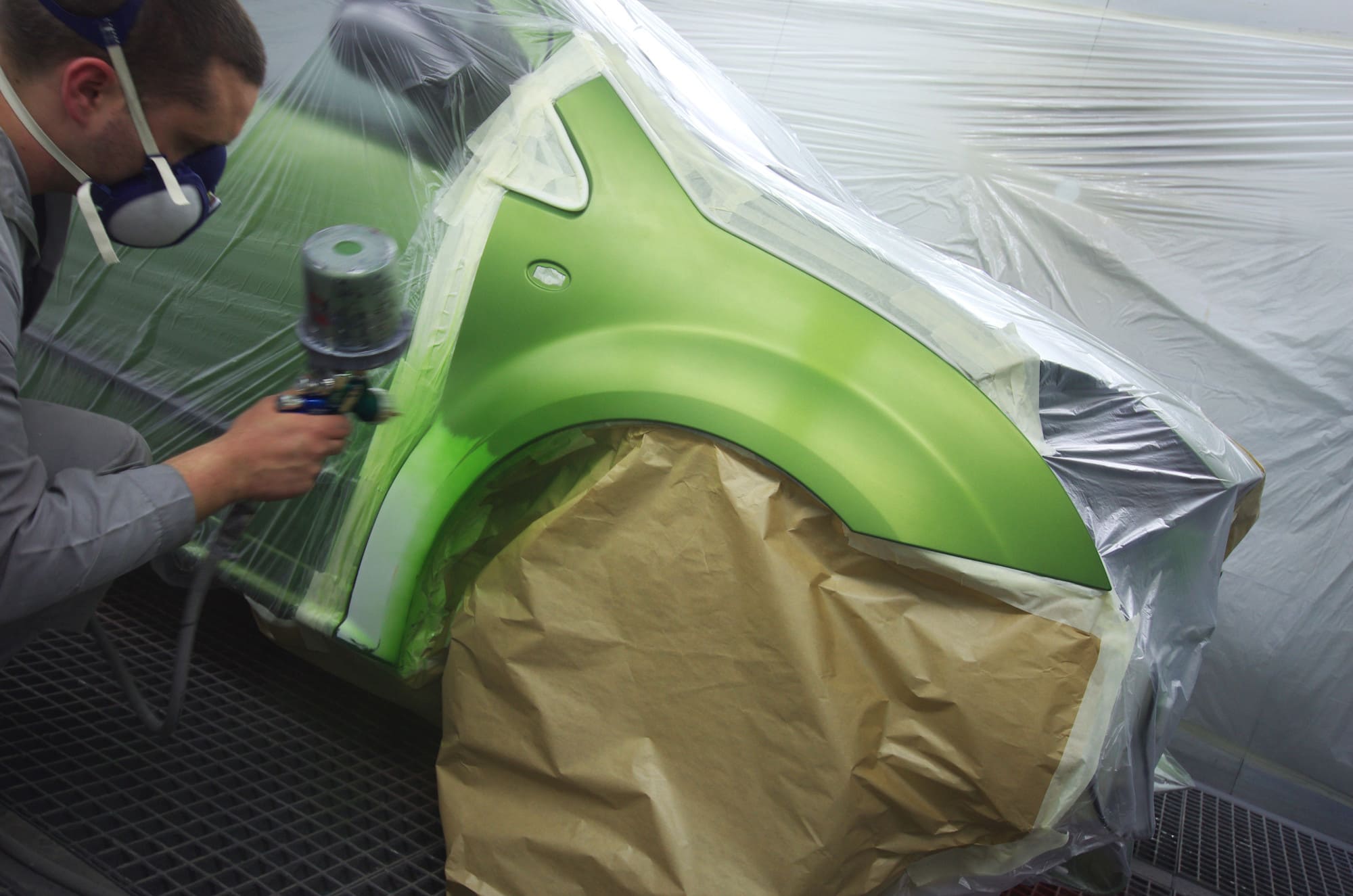 a man painting a car panel